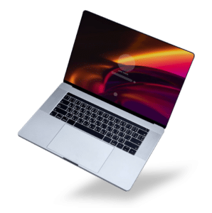 A silver MacBook Air, known for its sleek design and ease of repair, displays a colorful lock screen with abstract shapes from a high angle on a black background.