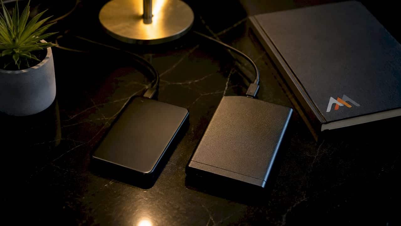 Close-up of two external hard drives on wooden desk