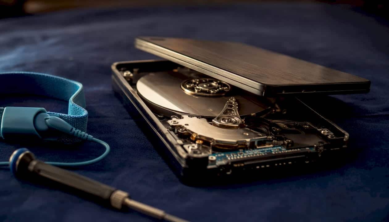 Close-up of opened external hard drive with tools