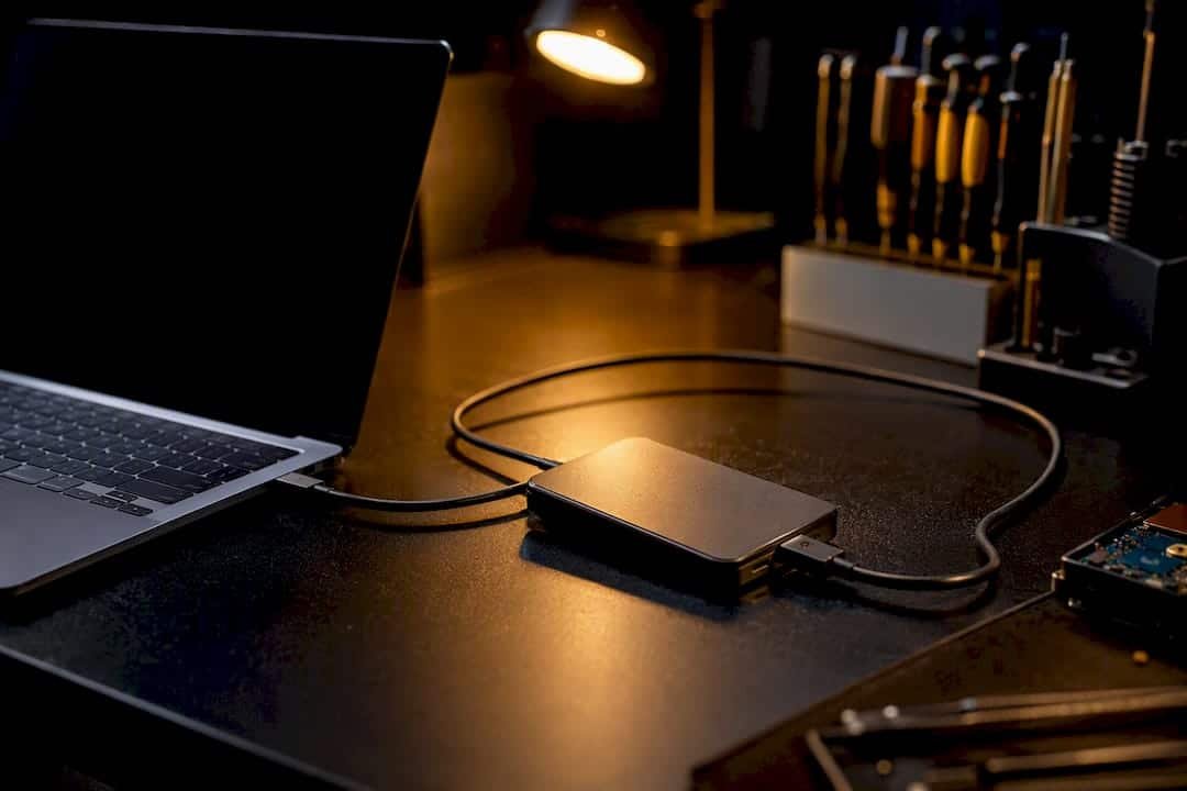 Close-up of external hard drive connected on repair bench