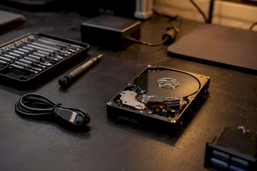 Opened external hard drive with battery pack nearby on bench