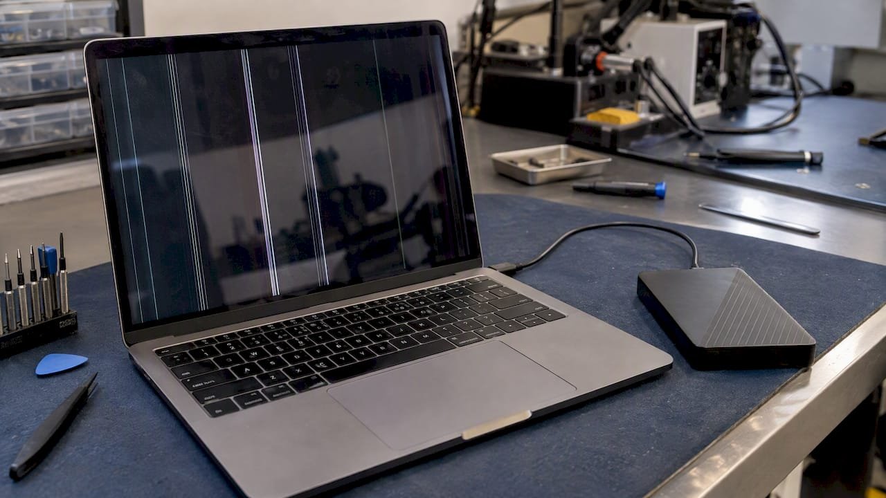 MacBook display showing vertical screen lines